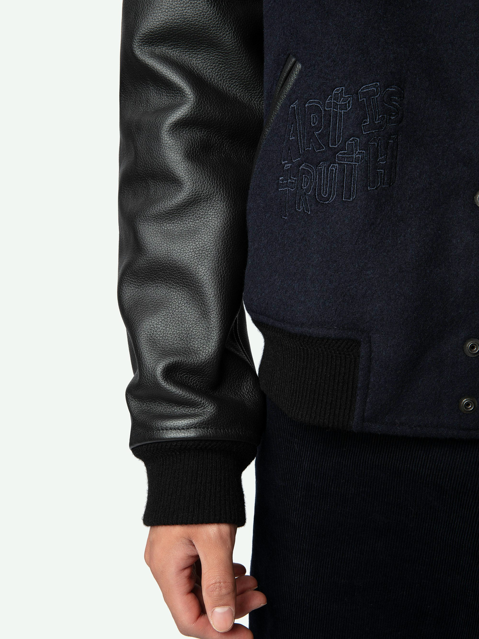 Birdieh Bomber Jacket - Blue wool bomber jacket with patterned grained leather pockets and panels, embroidery and XO skull badge.